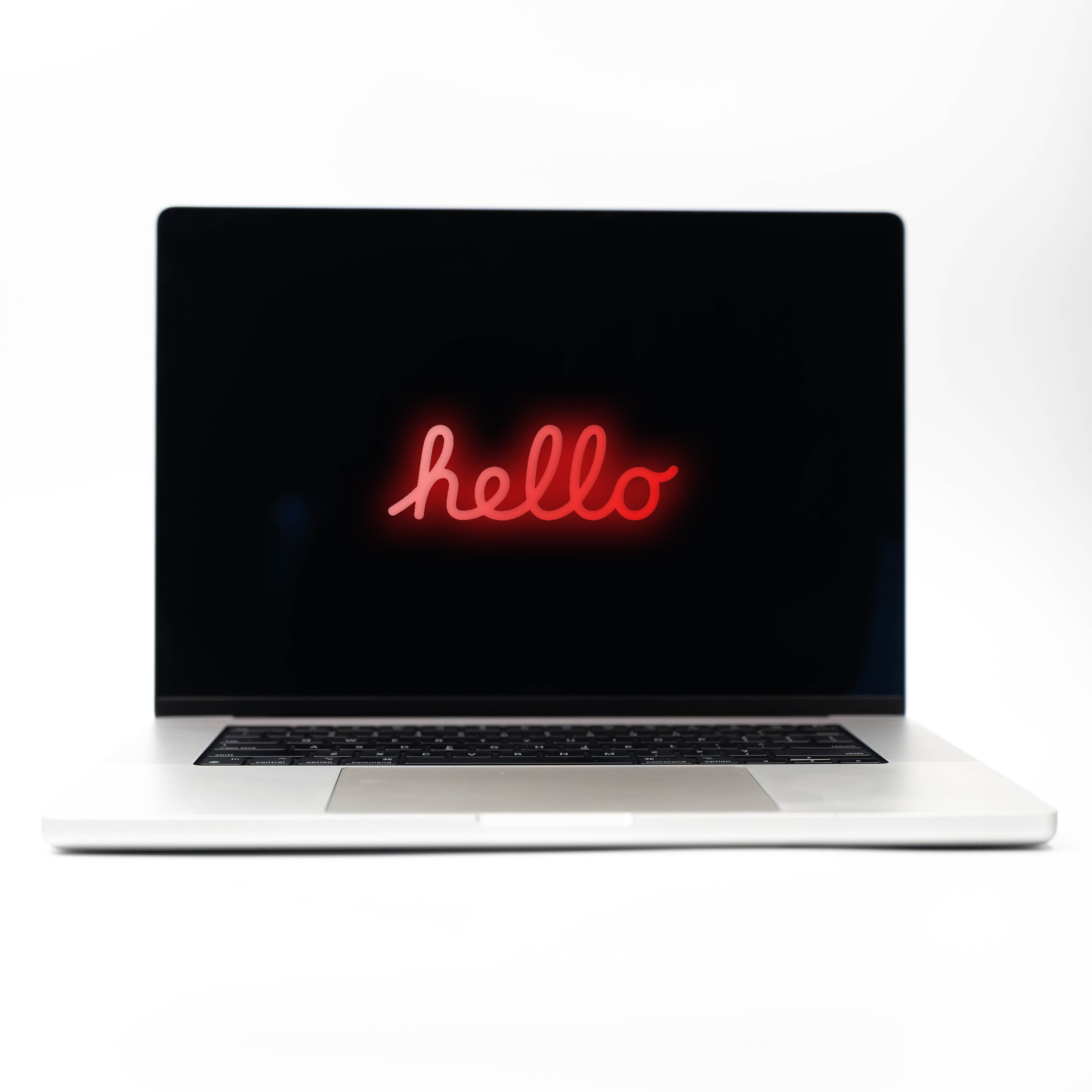 MacBook Pro 16 M2 Max Silver z czerwonym neonowym napisem Hello na ekranie