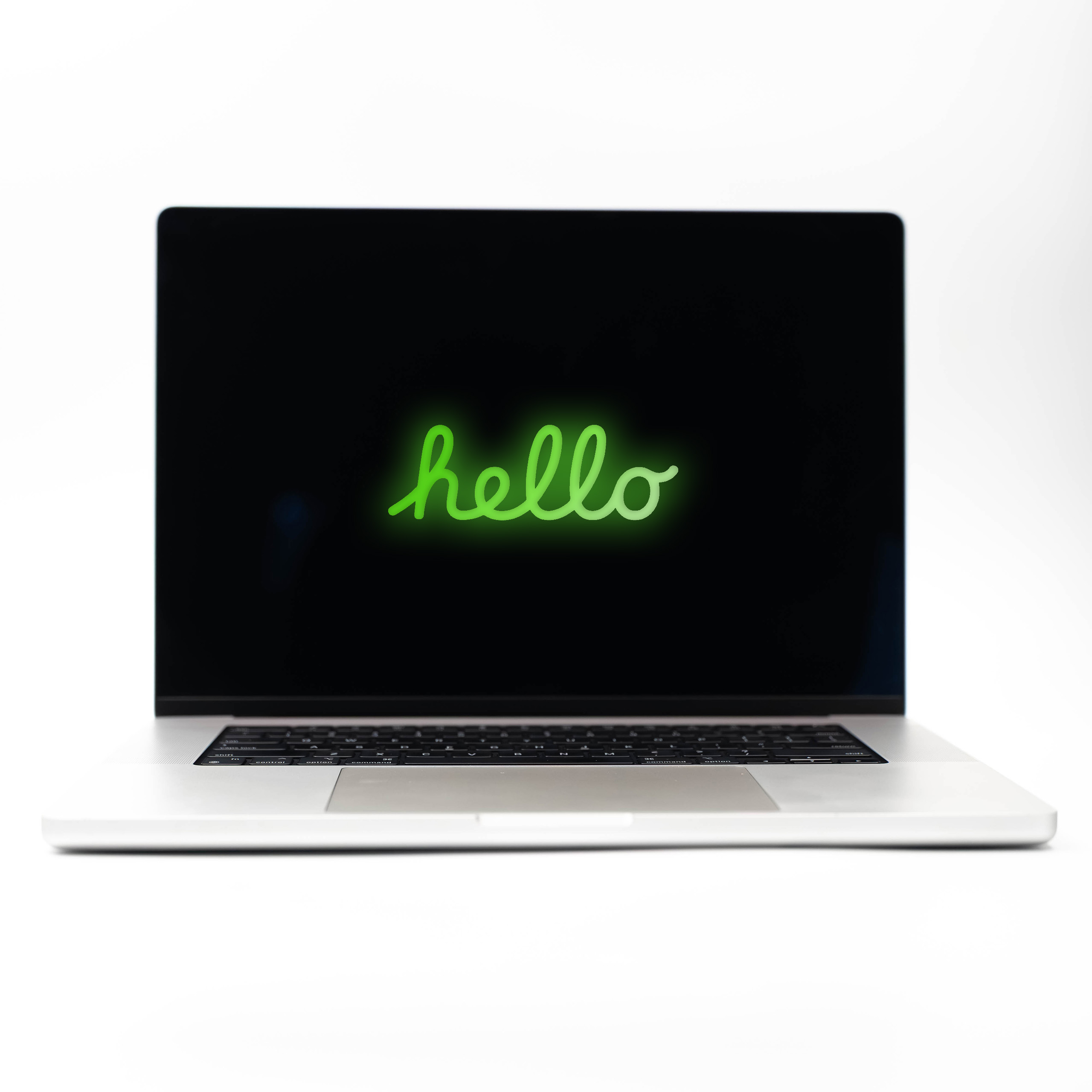 MacBook Pro 16 M4 Max Silver z zielonym neonowym napisem Hello na ekranie